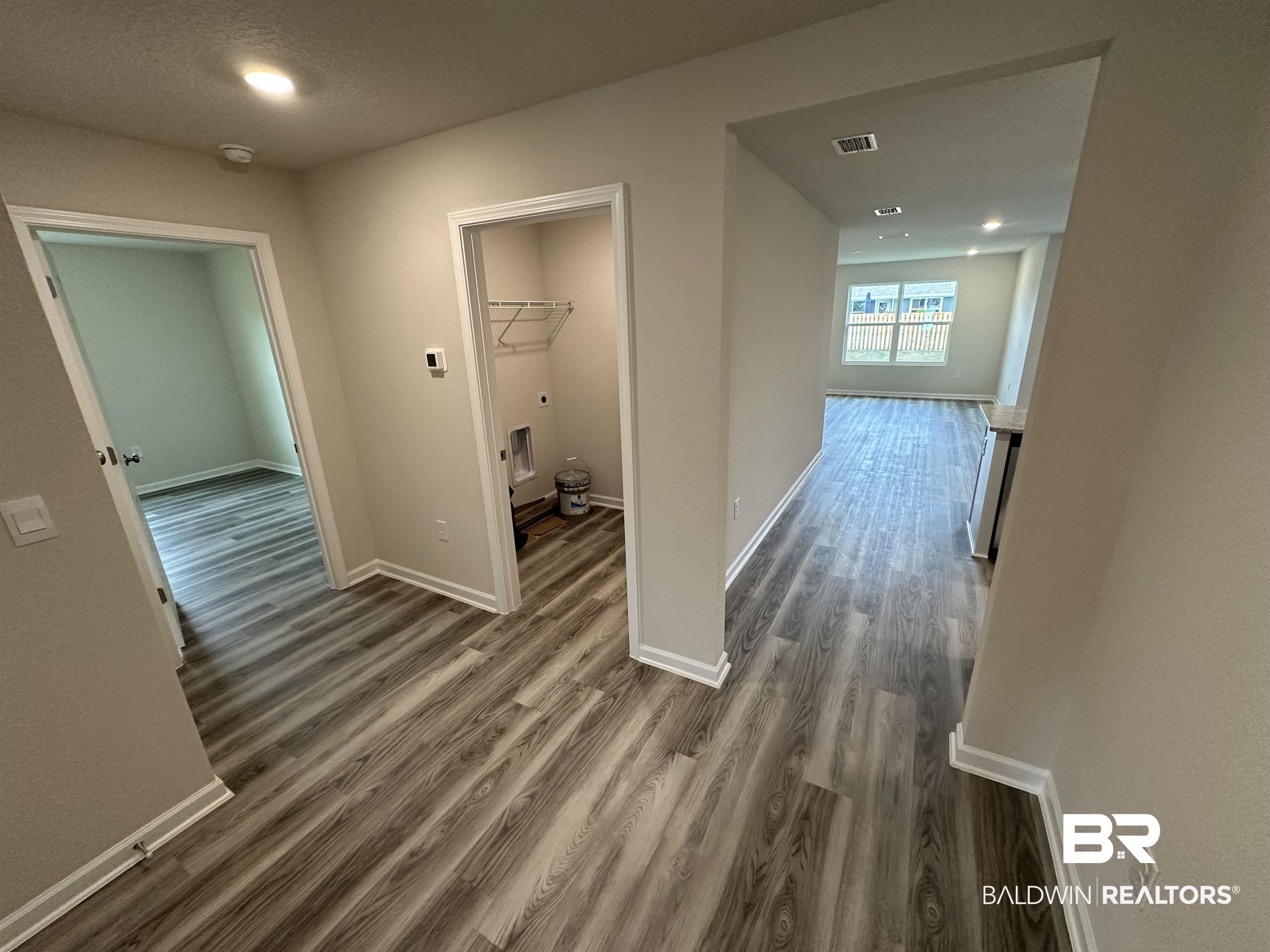 1238 Hayward Loop Foley, AL 36535 - Photo 16 of 46 Corridor featuring dark hardwood / wood-style flooring and a textured ceiling