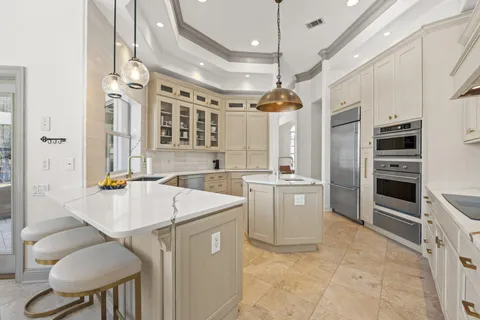 a kitchen with a sink stove and chairs