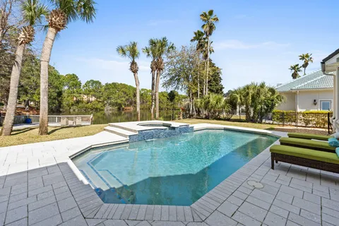 a view of swimming pool with outdoor seating and a yard