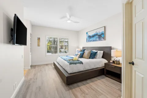 a bedroom with a bed and a flat screen tv