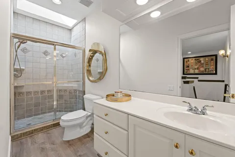 a bathroom with a sink toilet and shower