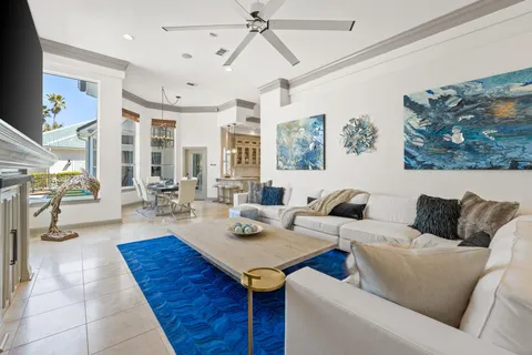 a living room with furniture a rug and white walls