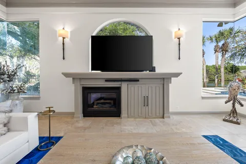 a living room with furniture a fireplace and a flat screen tv