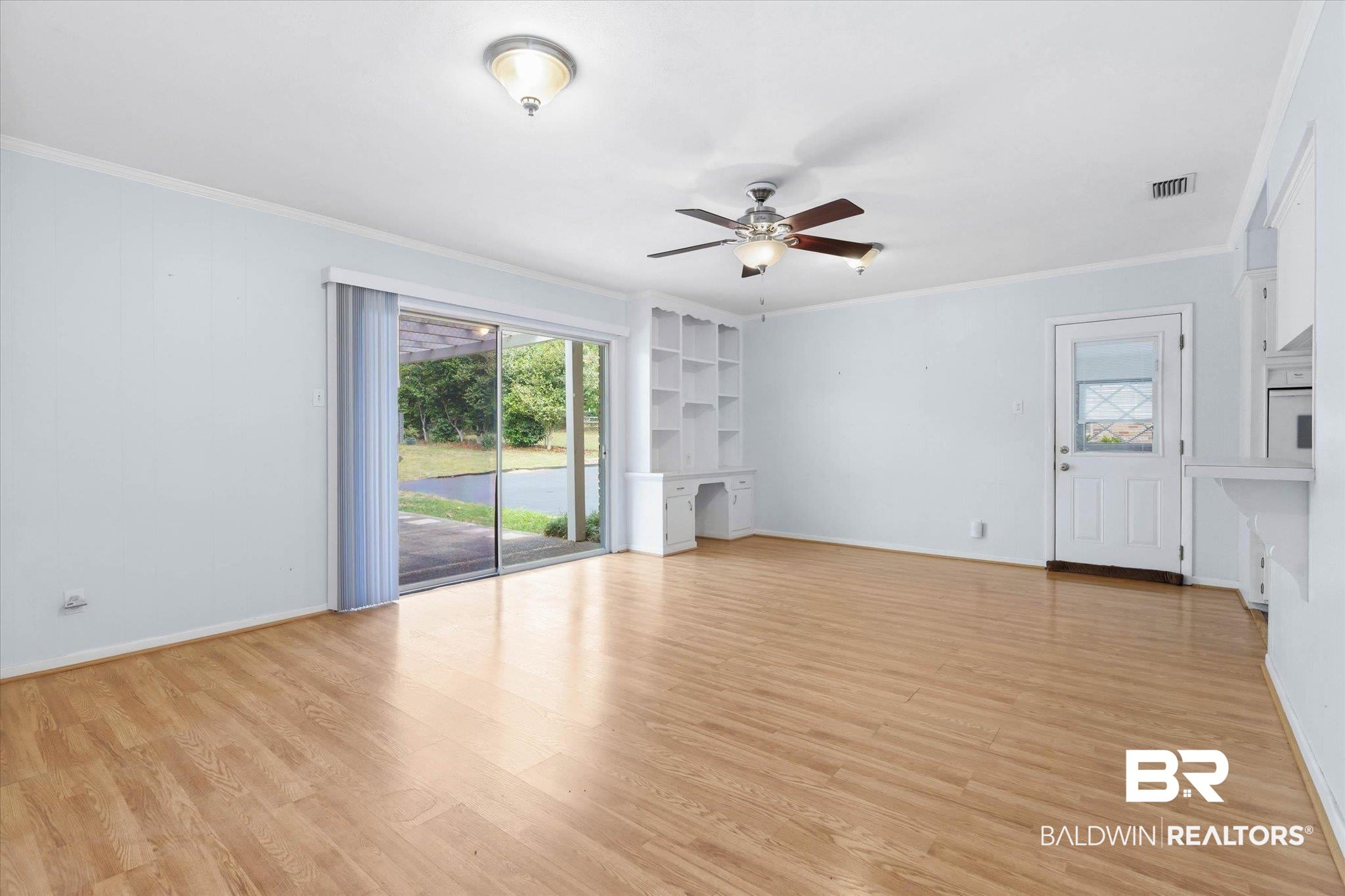 1182 Ginger Drive Mobile, AL 36693 - Photo 14 of 37 Spacious interior featuring wood-finish flooring, a ceiling fan, and built-in shelving with desk space