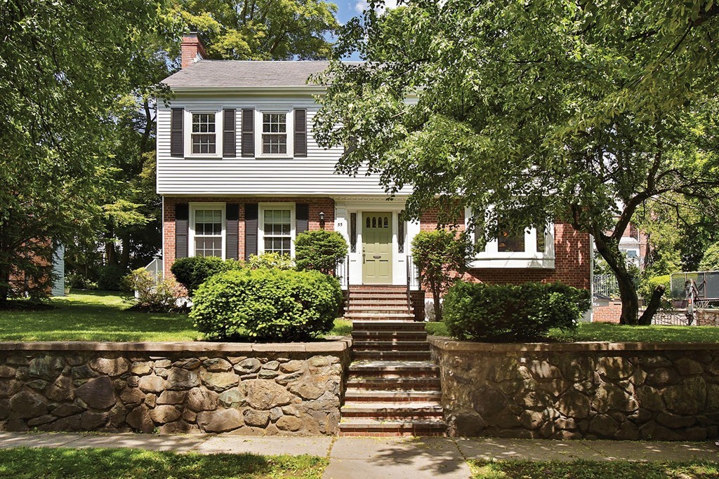 a front view of a house with a garden