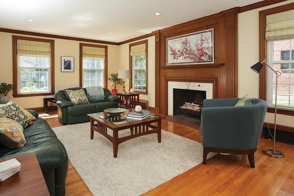 55 Welland Road Brookline, MA 02445 - Photo 3 of 9 a living room with furniture and a fireplace