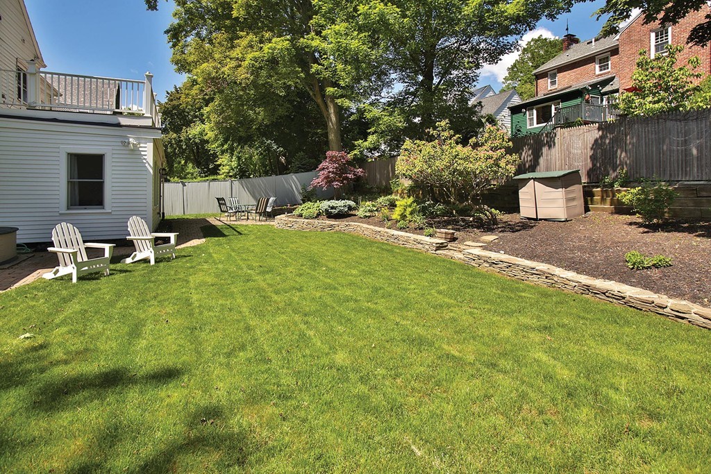 55 Welland Road Brookline, MA 02445 - Photo 9 of 9 a backyard of a house with table and chairs