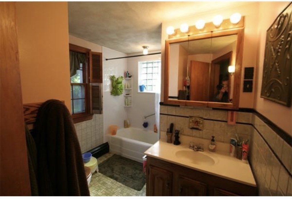 211 Russell Street Hadley, MA 01035 - Photo 11 of 20 a bathroom with a sink and mirror with toilet