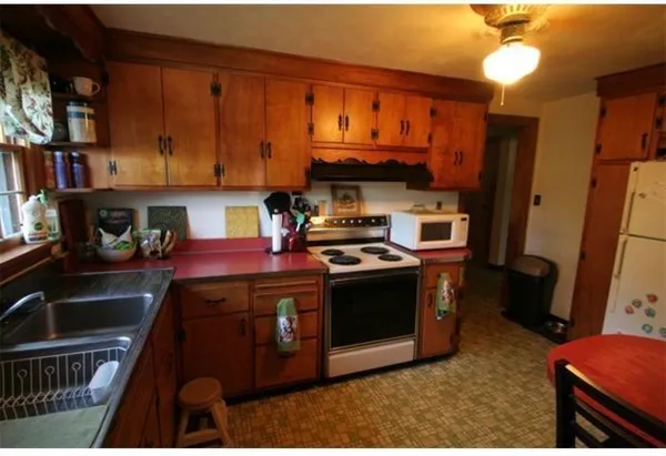 a kitchen with a stove and a refrigerator