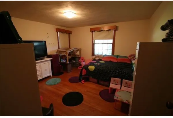 a bedroom with a bed and a television
