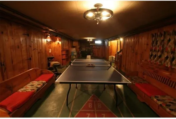 a room with pool table and chandelier