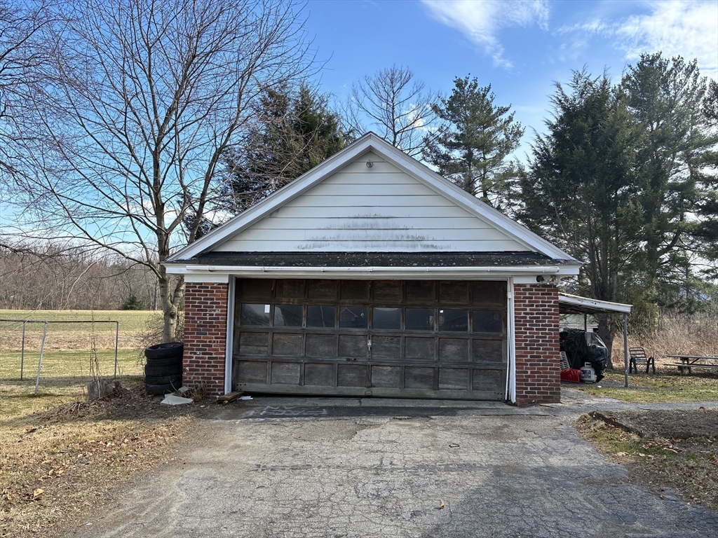 211 Russell Street Hadley, MA 01035 - Photo 2 of 20 a front view of a house with a yard and garage