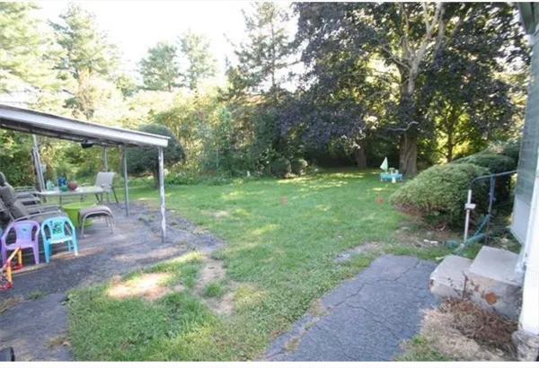 a view of a yard with porch and table
