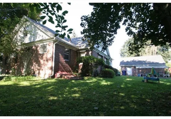 a view of a house with a yard porch and sitting area