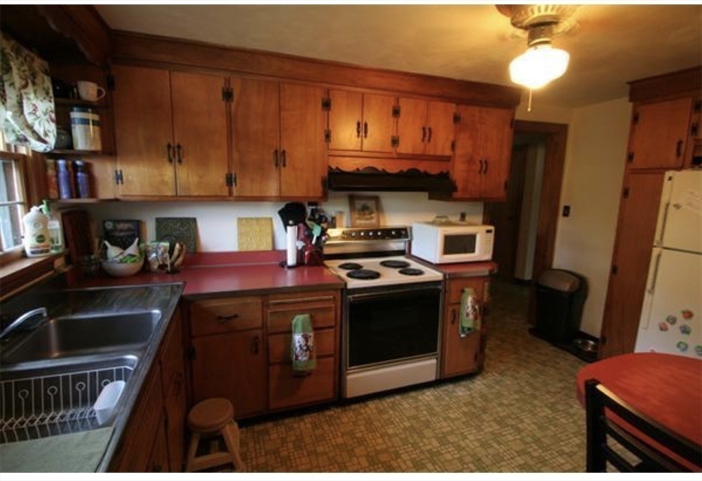 211 Russell Street Hadley, MA 01035 - Photo 7 of 20 a kitchen with a stove and a refrigerator