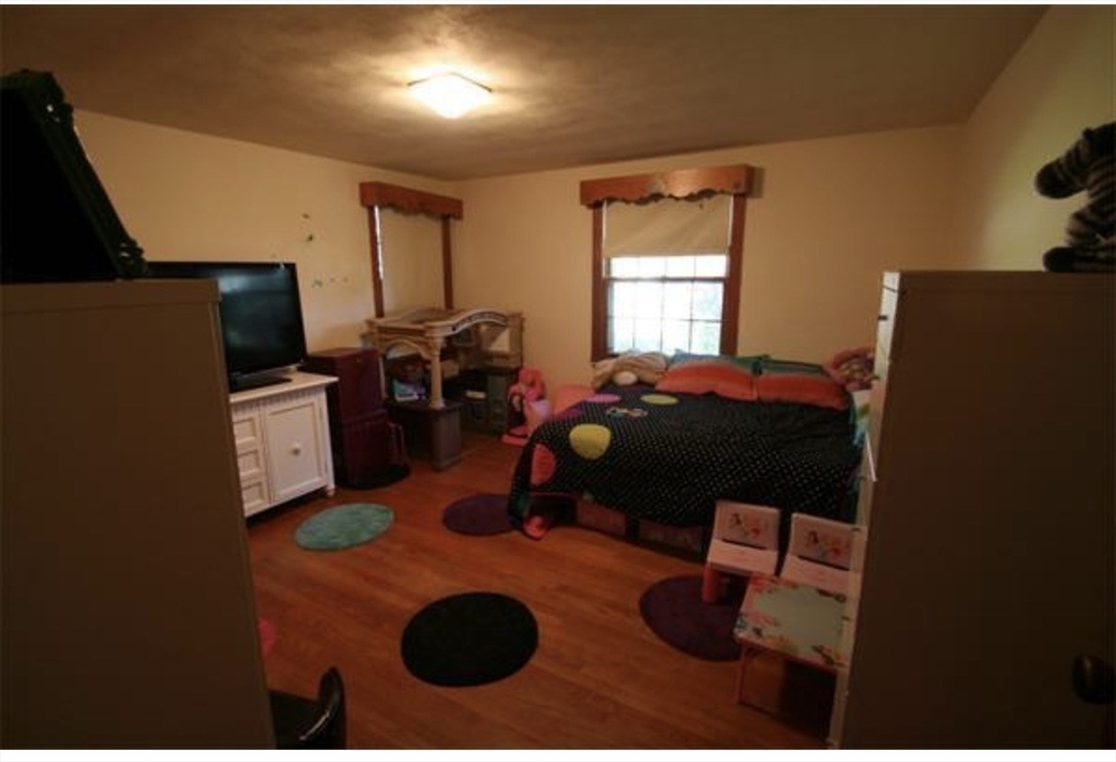 211 Russell Street Hadley, MA 01035 - Photo 10 of 20 a bedroom with a bed and a television