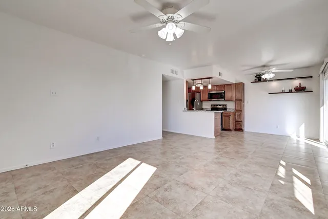 a view of a kitchen with a sink and a refrigerator