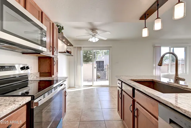 a kitchen with a sink cabinets and window
