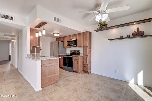 a large kitchen with cabinets and stainless steel appliances
