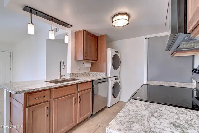 a spacious bathroom with a granite countertop sink a toilet and a mirror