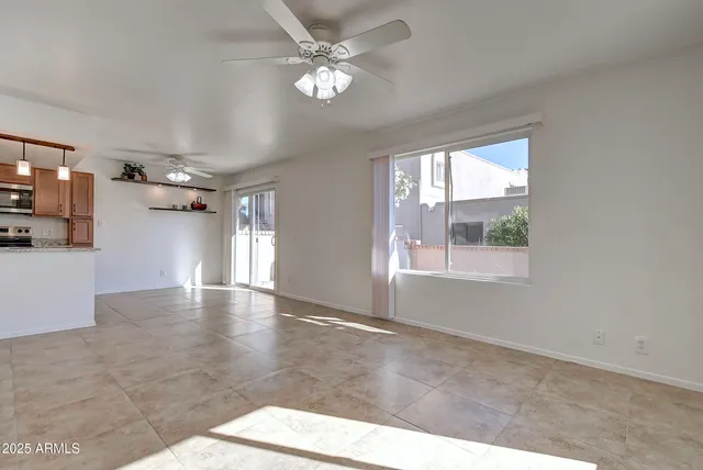 a view of a livingroom with a ceiling fan and window