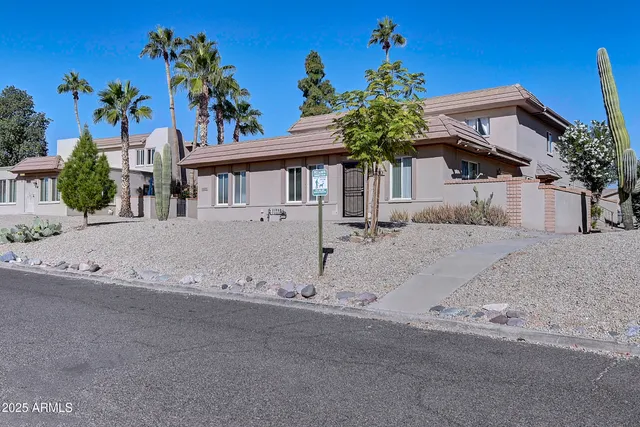 a house that has a tree in front of it