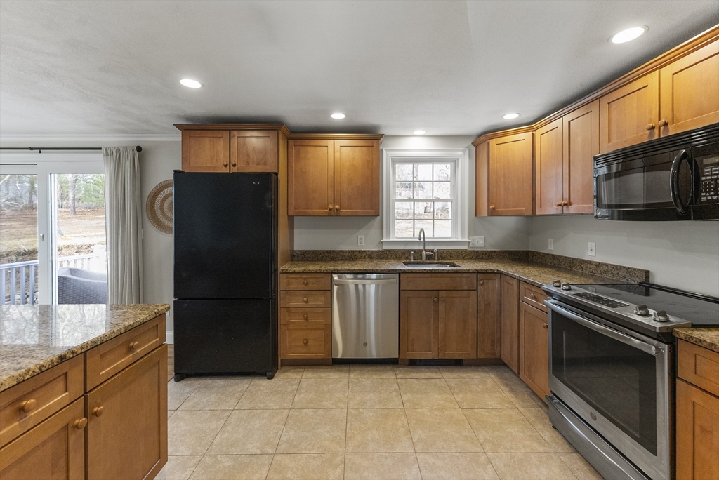 30 Pawtuxet Road Plymouth, MA 02360 - Photo 22 of 42 a kitchen with granite countertop a refrigerator and a stove top oven