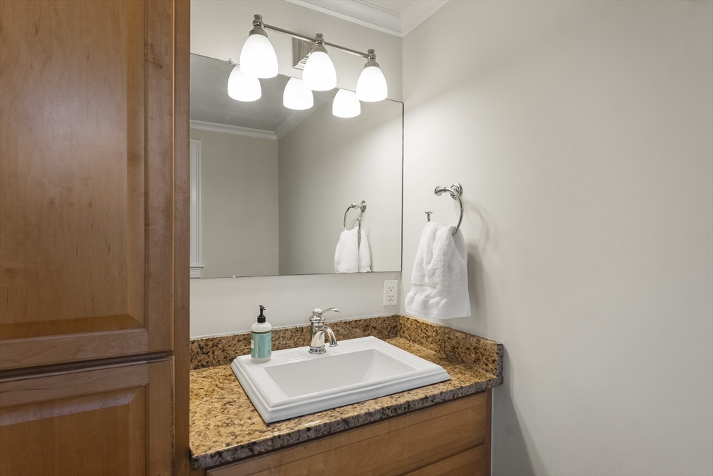 30 Pawtuxet Road Plymouth, MA 02360 - Photo 29 of 42 a bathroom with a granite countertop sink a mirror and vanity