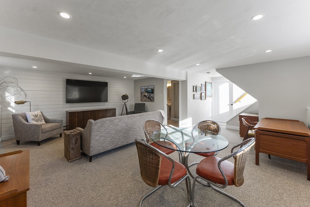 30 Pawtuxet Road Plymouth, MA 02360 - Photo 35 of 42 a living room with furniture and a flat screen tv