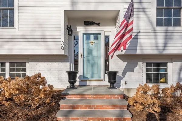 a kitchen with stainless steel appliances granite countertop a refrigerator a stove and a sink with wooden cabinets