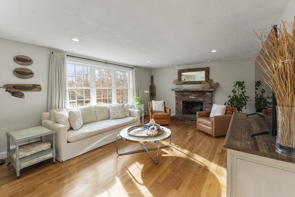 30 Pawtuxet Road Plymouth, MA 02360 - Photo 4 of 42 a living room with furniture a fireplace and a large window