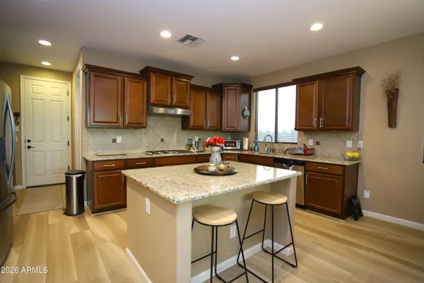 a living room with furniture a ceiling fan and a large window