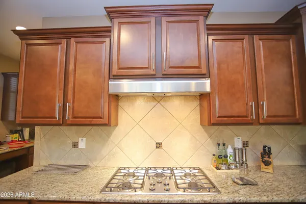 a kitchen with stainless steel appliances granite countertop a sink and cabinets