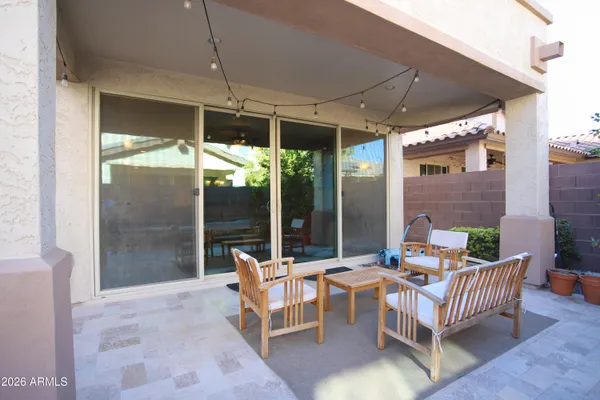 a view of patio with table and chairs under an umbrella