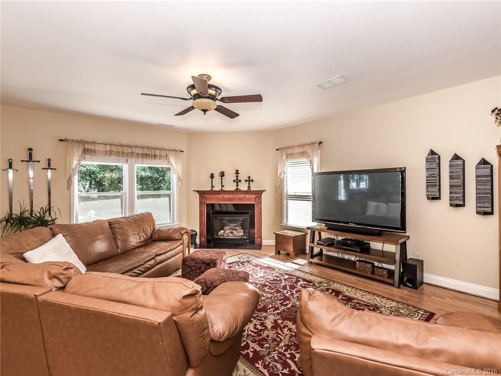2074 Durand Road, Unit 18 Fort Mill, SC 29715 - Photo 12 of 24 a living room with furniture a flat screen tv and a fireplace
