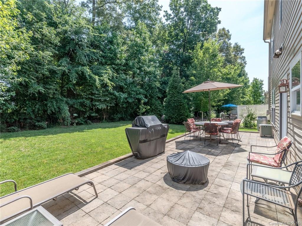 2074 Durand Road, Unit 18 Fort Mill, SC 29715 - Photo 23 of 24 a view of a patio with a dining table and chairs potted plants with large tree