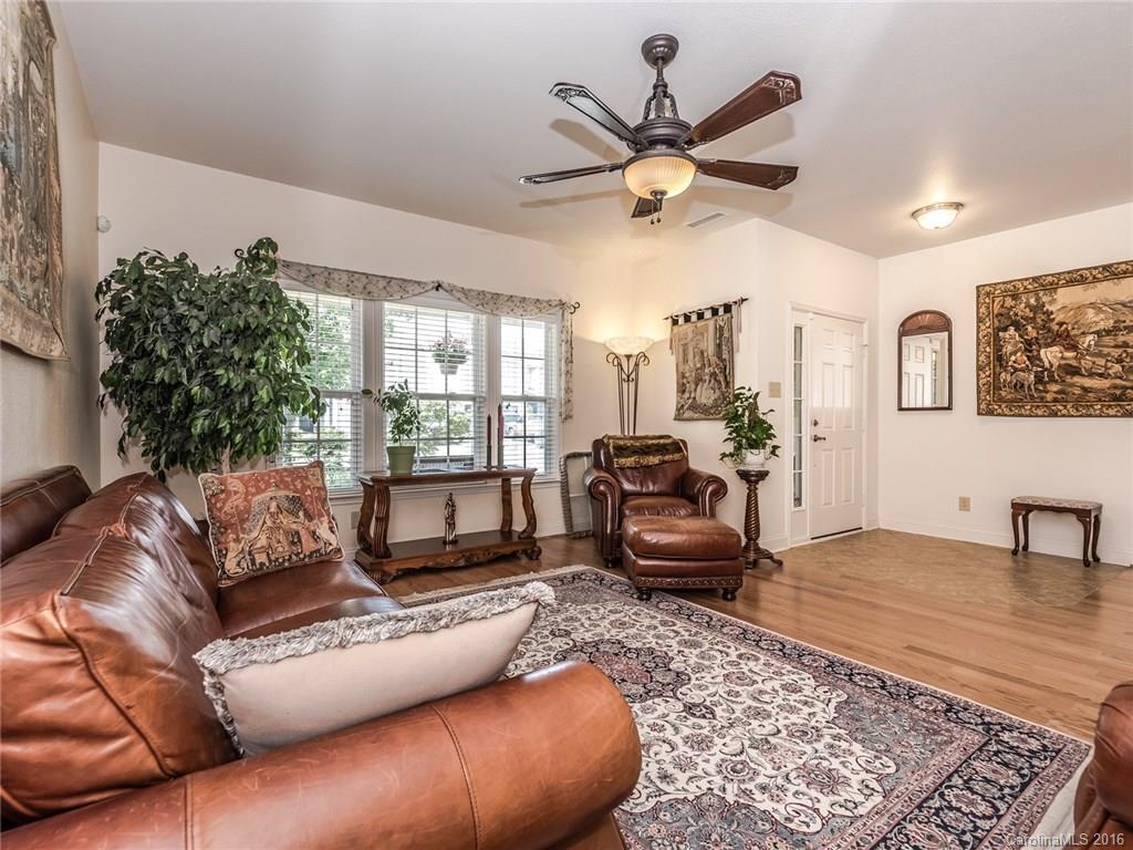 2074 Durand Road, Unit 18 Fort Mill, SC 29715 - Photo 4 of 24 a living room with furniture ceiling fan and a rug