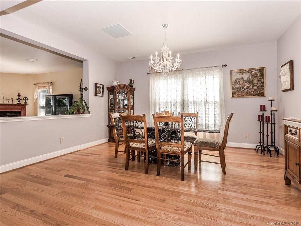 2074 Durand Road, Unit 18 Fort Mill, SC 29715 - Photo 5 of 24 a view of a dining room with furniture and wooden floor