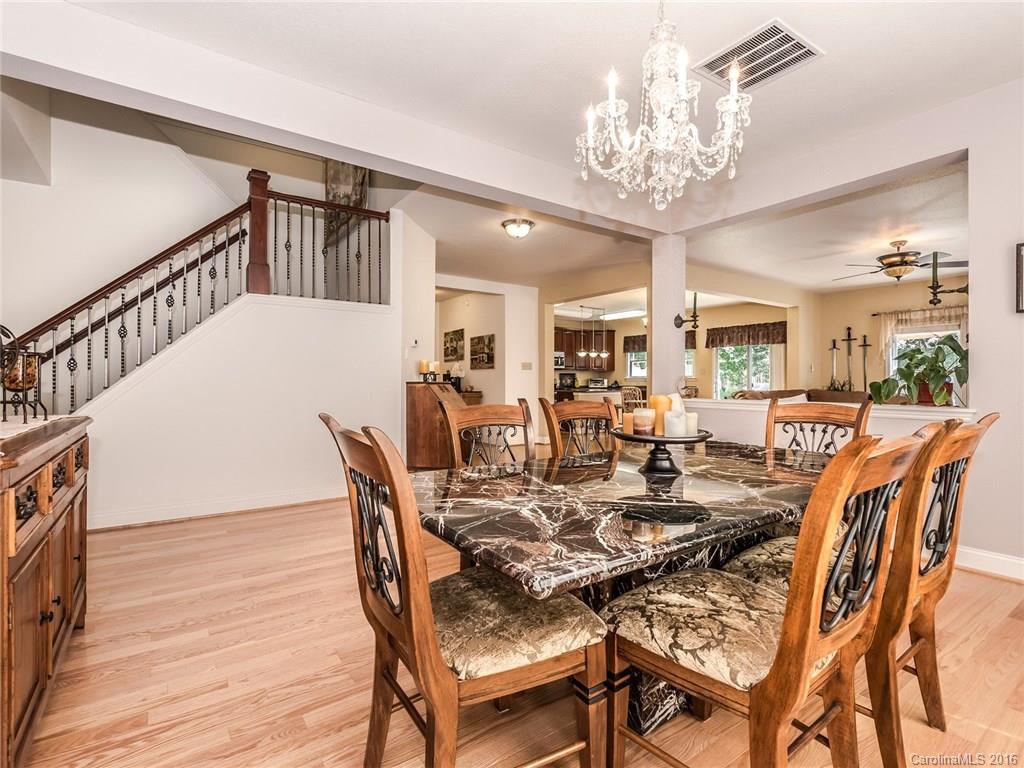 2074 Durand Road, Unit 18 Fort Mill, SC 29715 - Photo 6 of 24 a view of a dining room with furniture and wooden floor
