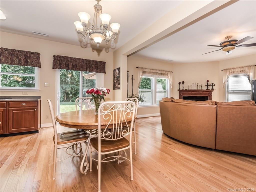 2074 Durand Road, Unit 18 Fort Mill, SC 29715 - Photo 7 of 24 a dining room with furniture a chandelier and wooden floor