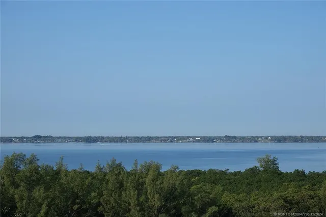 a living room with lots of furniture and windows
