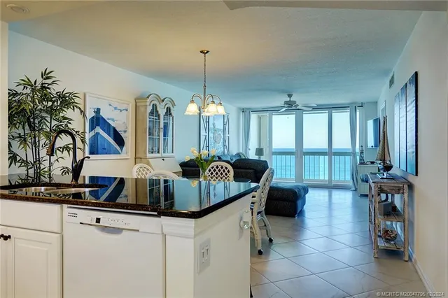 a view of a kitchen with stainless steel appliances granite countertop a sink and cabinets