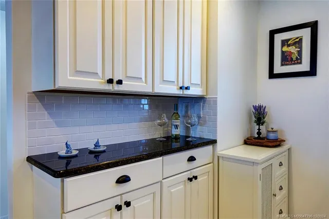 a kitchen with stainless steel appliances kitchen island granite countertop a sink and cabinets