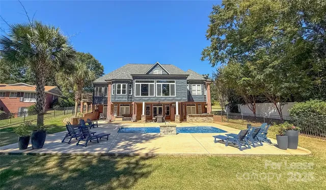 a view of a house with swimming pool and sitting area