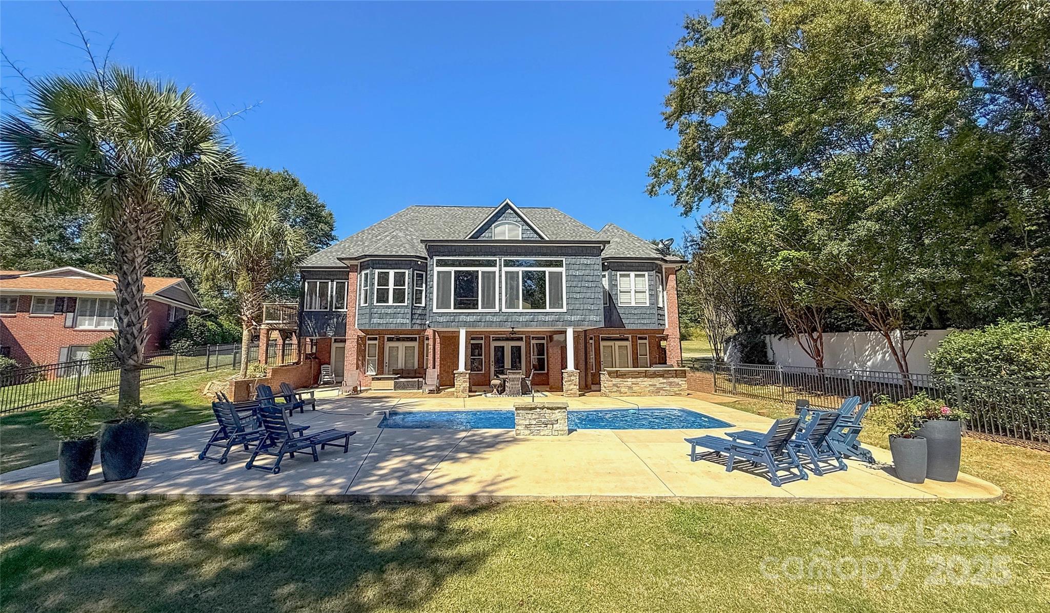a view of a house with swimming pool and sitting area
