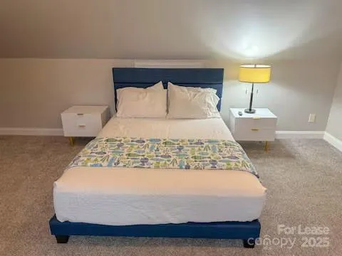 a bedroom with bed and window