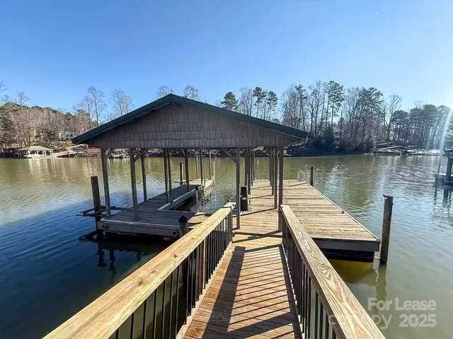 an aerial view of a house with a yard swimming pool and outdoor seating