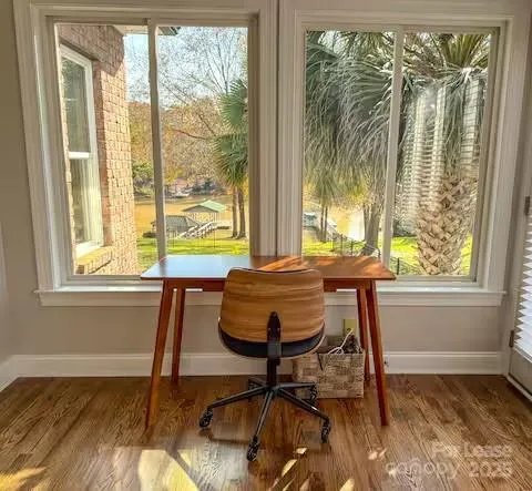 a view of a room that has a bed and a chair in it