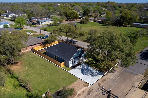 an aerial view of a house with a yard