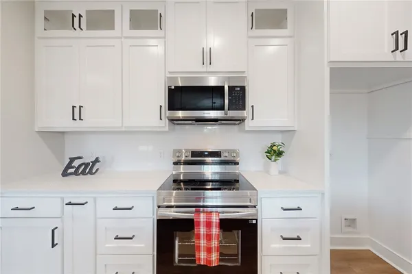 a kitchen with a stove and cabinets